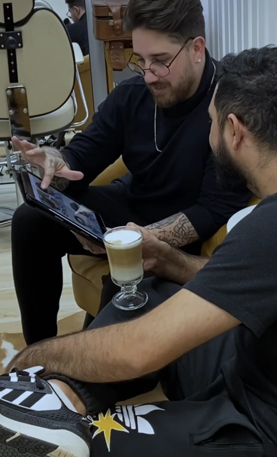 André Padilha explicando a proposta enquanto o cliente acompanha com um café.